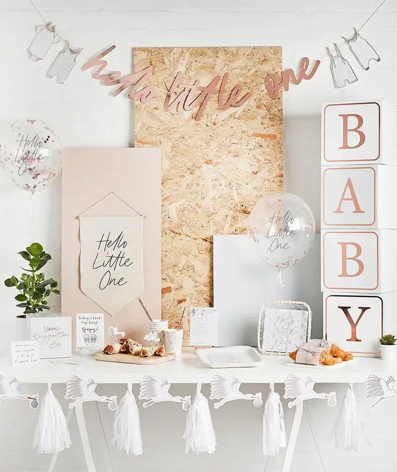 Neutral-toned first birthday party display with baby-themed decorations, pastel balloons, stacked BABY blocks, tableware, and a decorative dessert table. Neutral-toned first birthday party display with baby-themed decorations, pastel balloons, stacked BABY blocks, tableware, and a decorative dessert table.